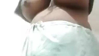 Mature Desi whore shows off her immense XXX tits for horny clients