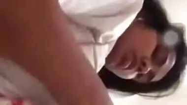 Girl performs XXX show and pulls up white T-shirt to expose boobs