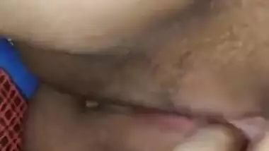 Indian woman touches her pink vagina with two hands in close-up porn